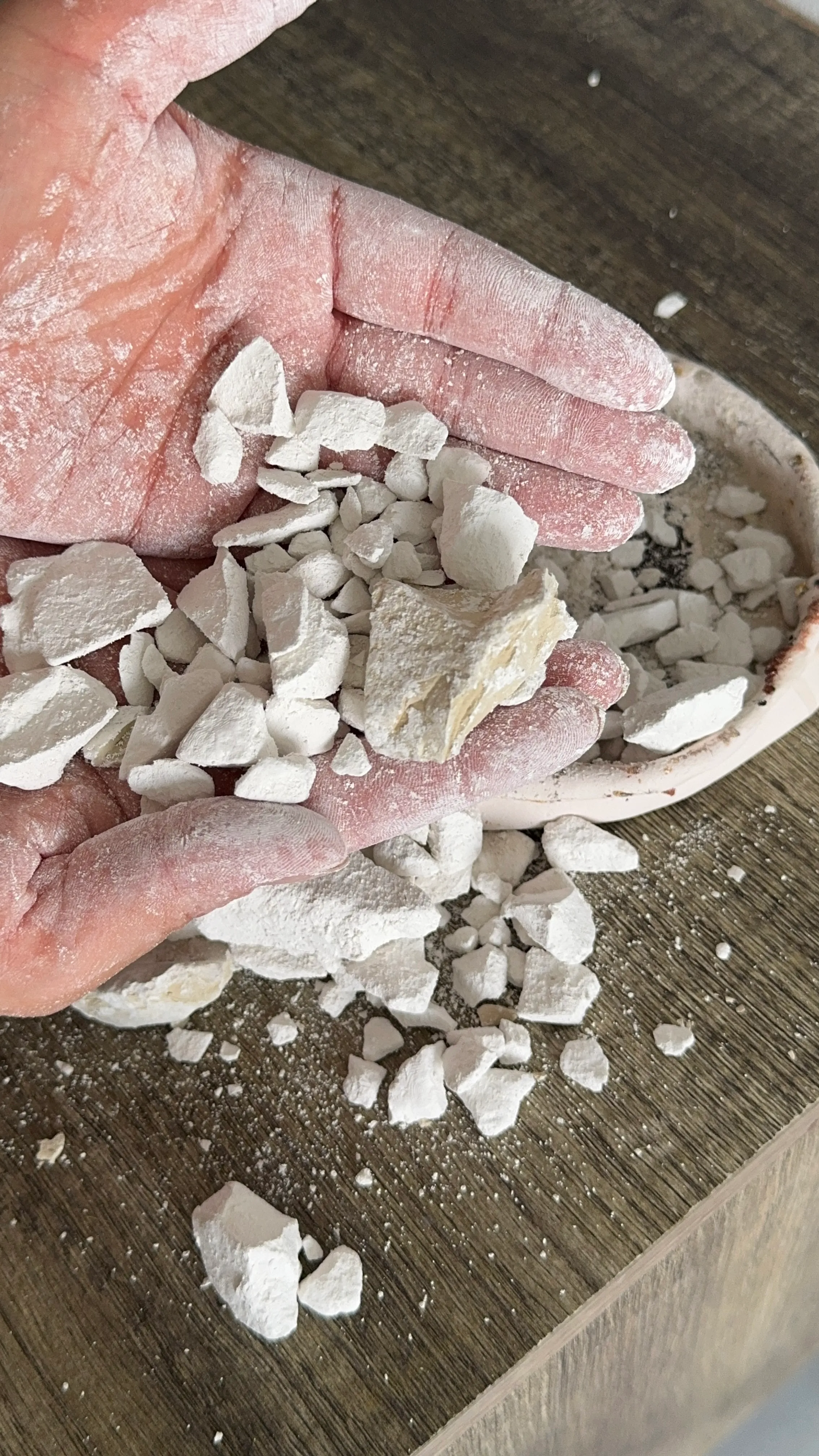 Pieces of white pigment in the artist's hand